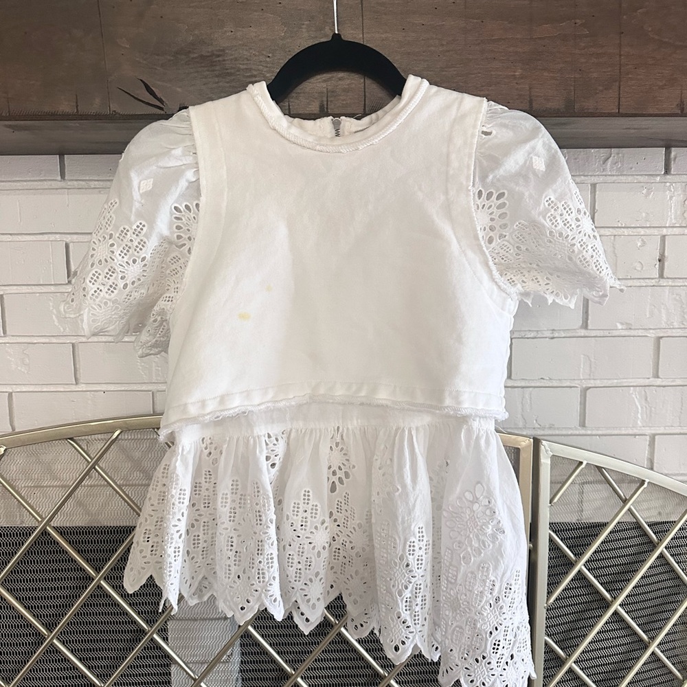 Short sleeved asymmetrical eyelet top